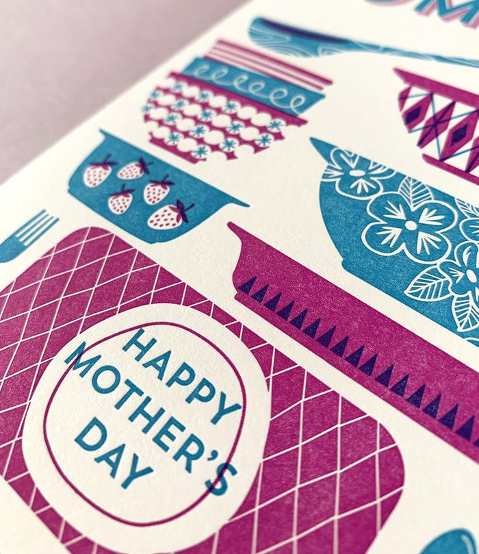 By Paper Parasol Press. Send your mom some pyrex cheer for Mother's Day! Dishing Out the Love Card details: A2 Size. 2 color letterpress printed card. Blank interior. Comes with a light purple envelope. Printed in the USA.