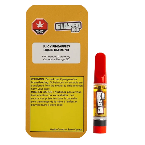 Bright studio front view of the Juicy Pineapples Liquid Diamond Vape Cartridge showing its yellow-labeled box with warning panel beside a red-tipped 1 g cartridge.