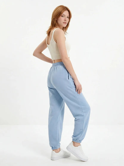Damskie spodnie dresowe oversize UNLEASH WINGS PASTEL BLUE WINGS UNLEASH