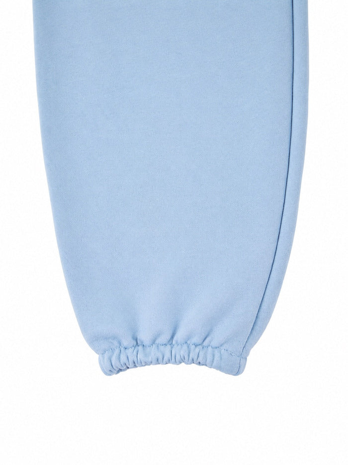 Damskie spodnie dresowe oversize UNLEASH WINGS PASTEL BLUE WINGS UNLEASH