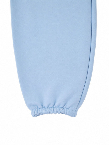 Damskie spodnie dresowe oversize UNLEASH WINGS PASTEL BLUE WINGS UNLEASH